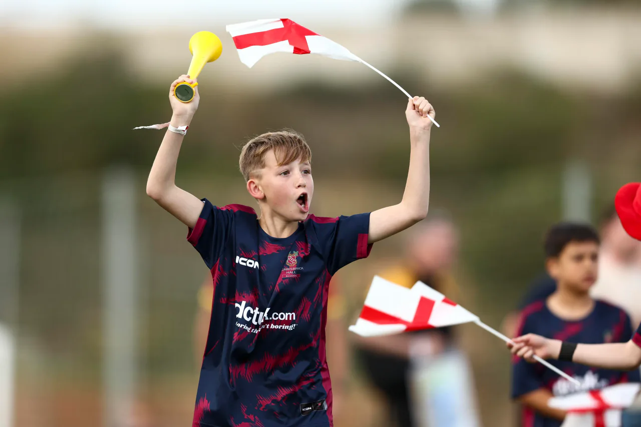 A young supporter waving England flags