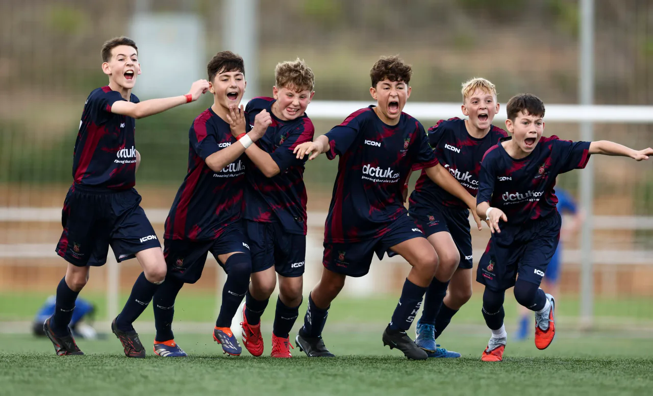 A team sprinting off to celebrate a goal