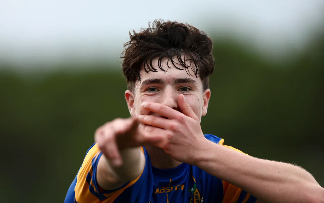 A boy pointing at the camera after scoring
